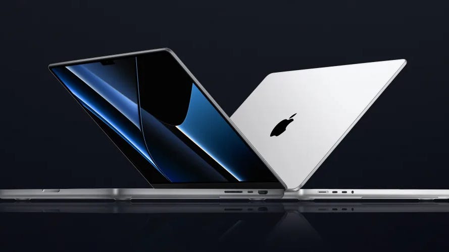 Two half-open MacBook Pros