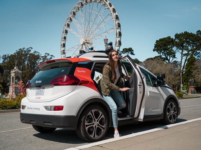 A woman leaving a driverless Cruise taxi