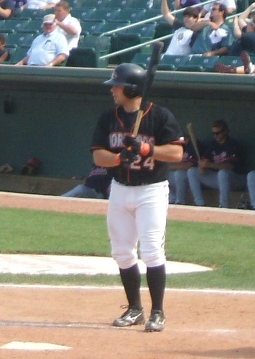 Shorebird catcher Zach Dillon checks his sign during a recent game.