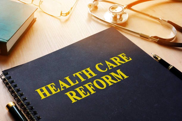 Book with title health care reform on a desk. Book with title health care reform on a desk. healthcare reform stock pictures, royalty-free photos & images
