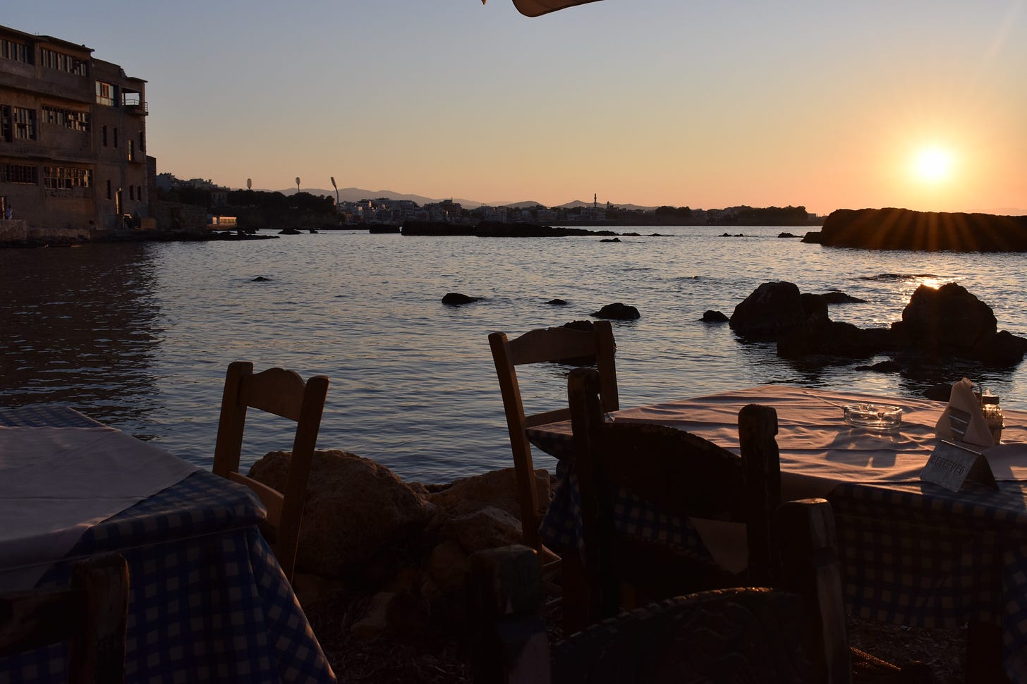 Tables by the sea at sunset