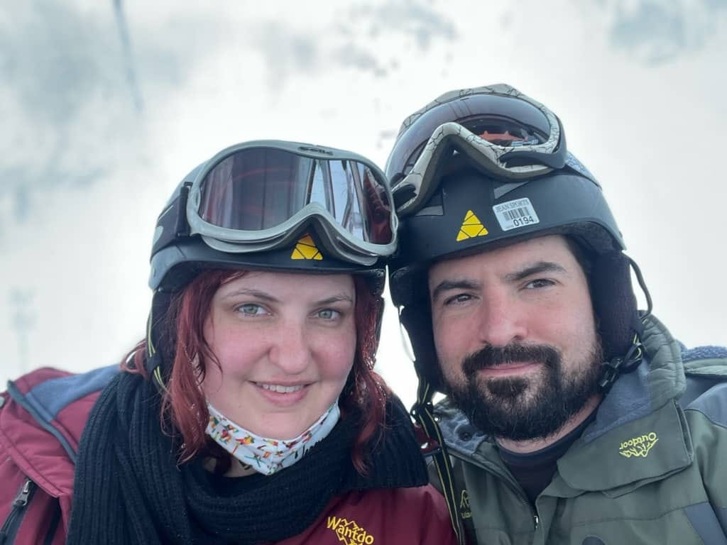 Selfie of Kristy and Joel on the lift going up the mountain.