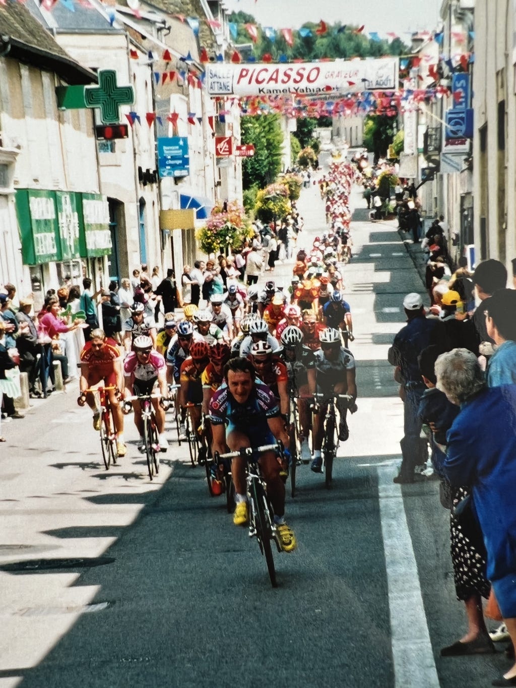 A group of professional cyclists from the Tour de France enter French town, 2000