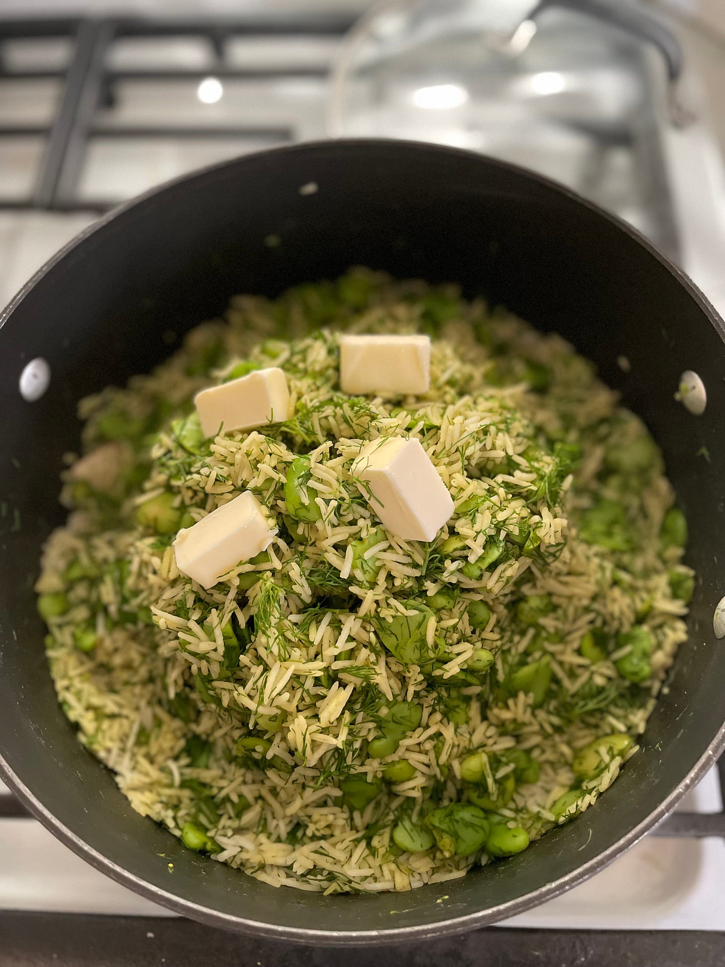 Dill fava bean rice mixture with butter on top