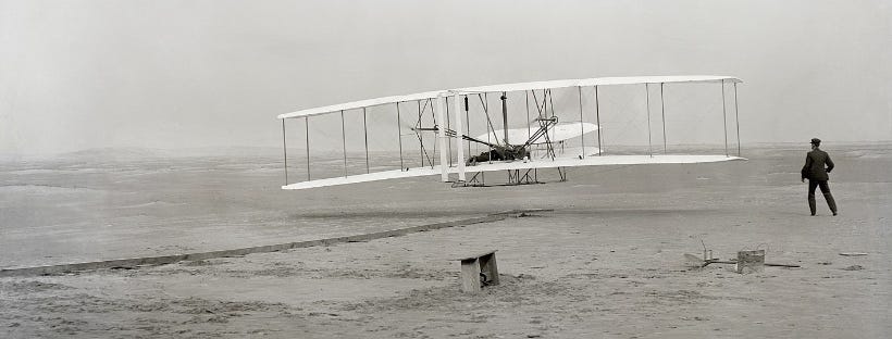 By John T. Daniels - File:Wright_first_flight.tif, Public Domain, https://commons.wikimedia.org/w/index.php?curid=75148383