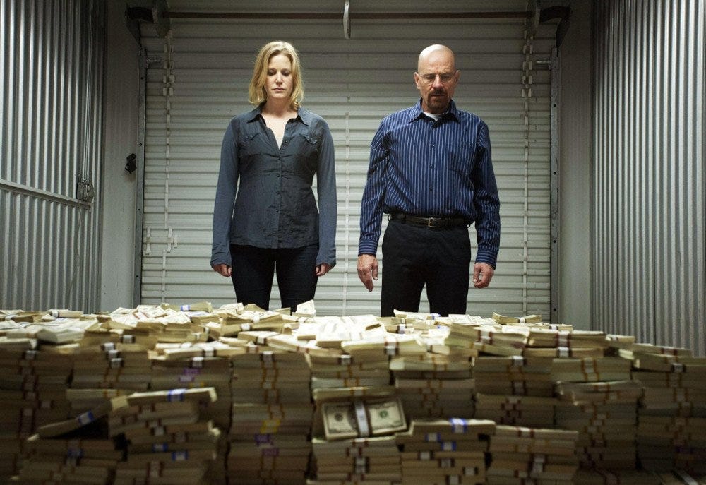 https://www.scienceabc.com/wp-content/uploads/2018/01/Breaking-bad-scene-where-Walter-White-and-Skylar-stand-in-front-of-a-huge-pile-of-cash.jpg