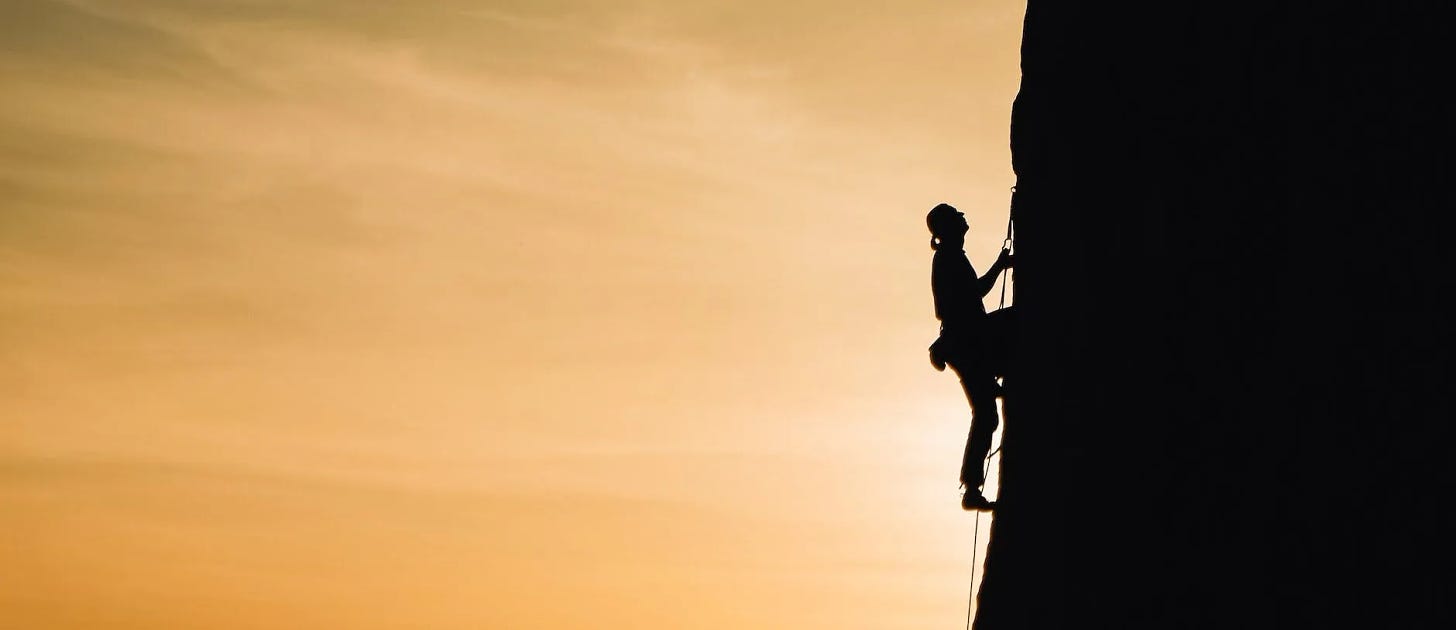 person rock climbing