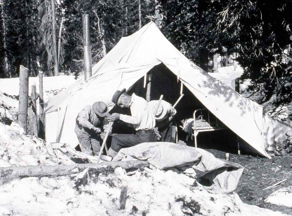 1929. Some of the control crew sharpening axes. Munson beetle control camp, Crater Lake National Park, Oregon.