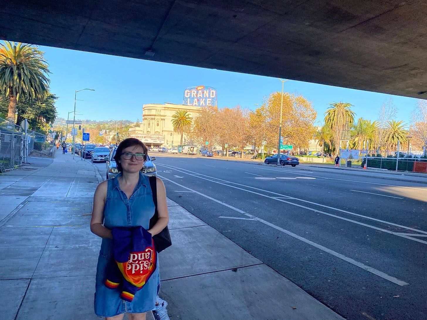 A picture of me wearing a light blue dress standing under an underpass.