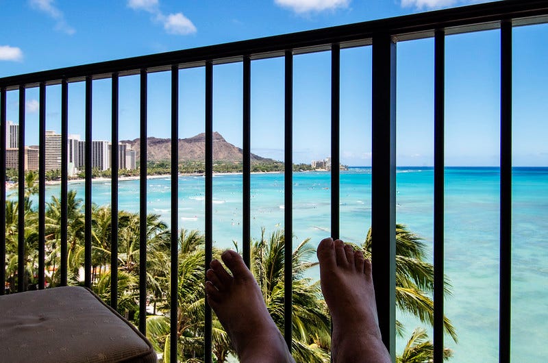 Feet on a bolster overlooking Waikiki
