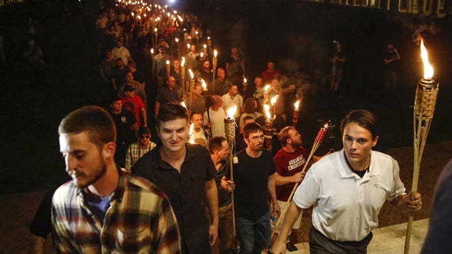 White nationalists march with torches through the UVA campus in Charlottesville, Va., on Aug.11, 2017.
