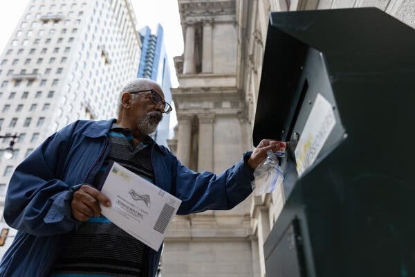 A resident drops off a mail-in ballot in Philadelphia.