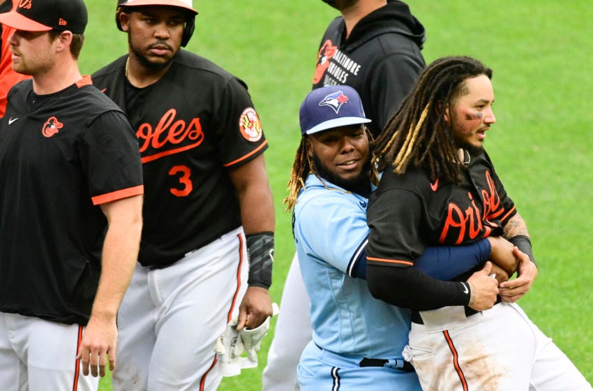 Vladdy carries his son Freddy Galvis away from a bench-clearing kerfuffle, as Maikel Franco looks on jealously.