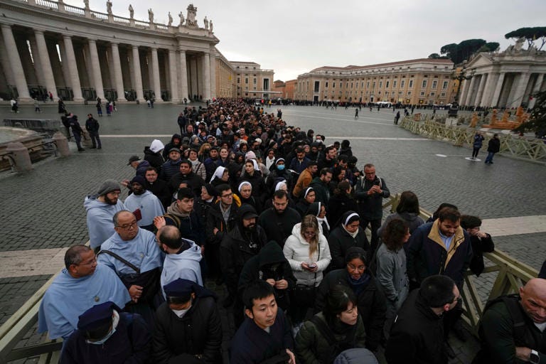 People wait in a line to enter Saint Peter's Basilica at the Vatican where late Pope Benedict 16 is being laid in state at The Vatican, Monday, Jan. 2, 2023. Benedict XVI, the German theologian who will be remembered as the first pope in 600 years to resign, has died, the Vatican announced Saturday. He was 95. AP Photo/Alessandra Tarantino