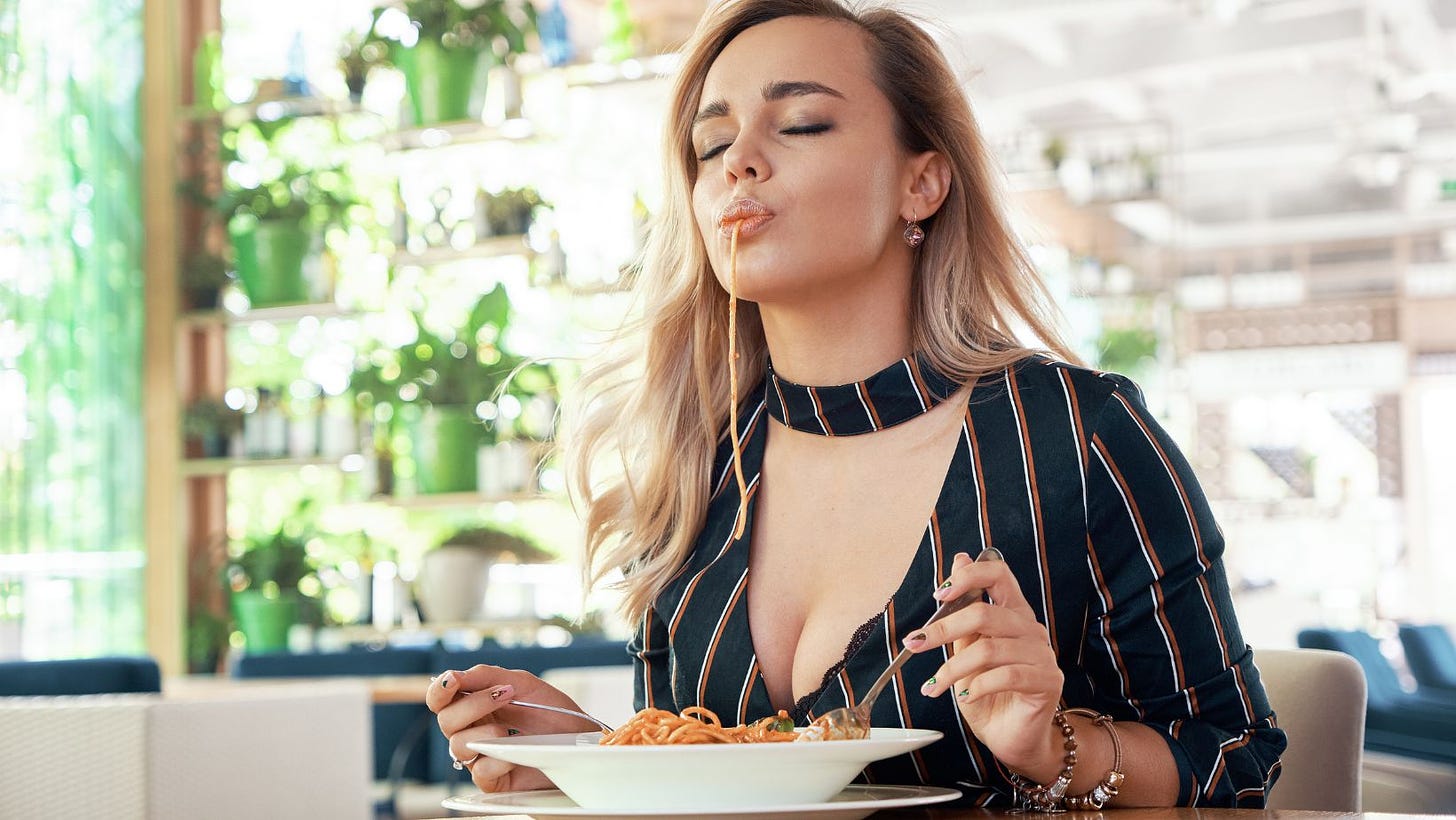 a sexy woman eats spaghetti seductively