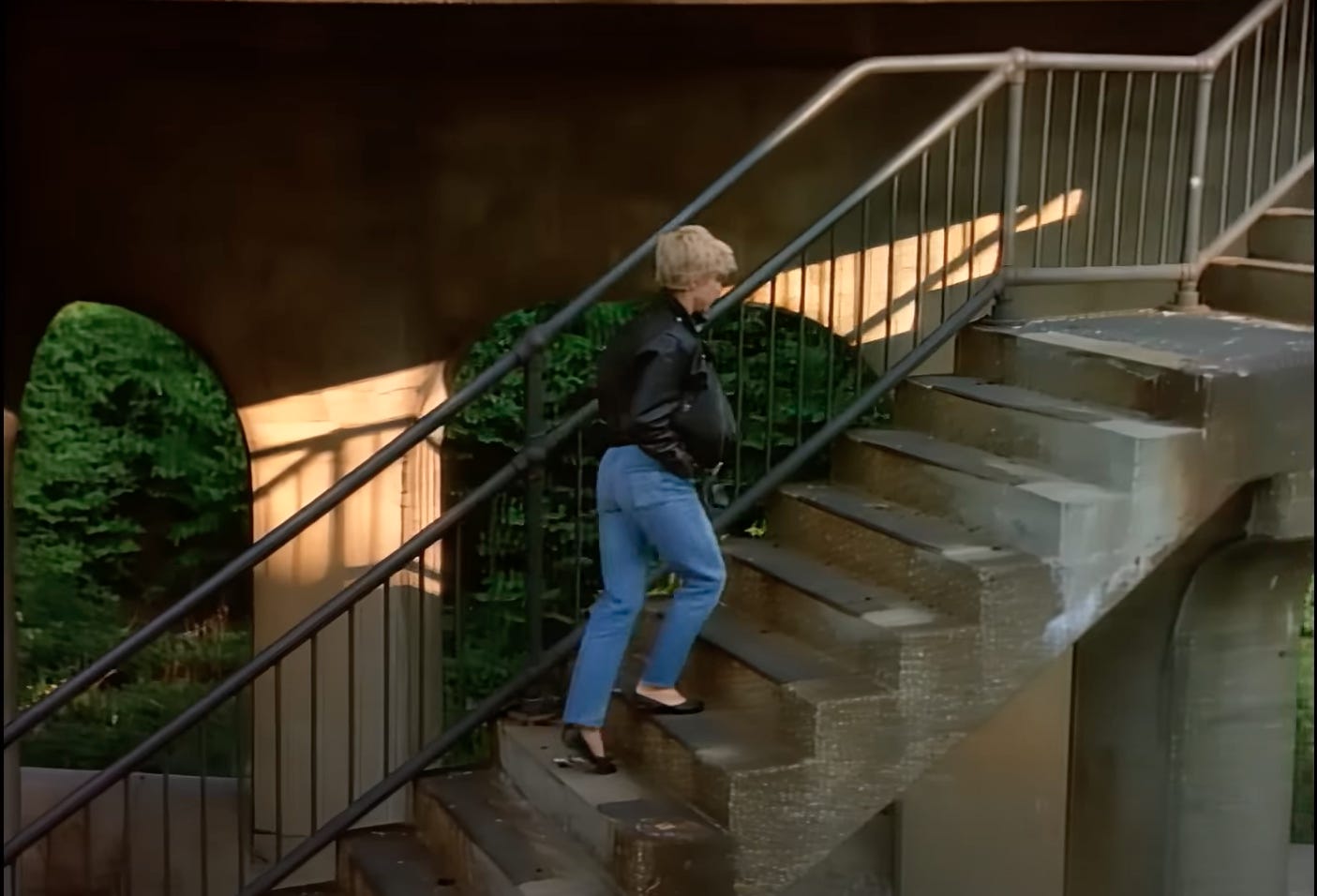 Screenshot from Madonna's Papa Don't Preach video showing Madge walking up some stairs