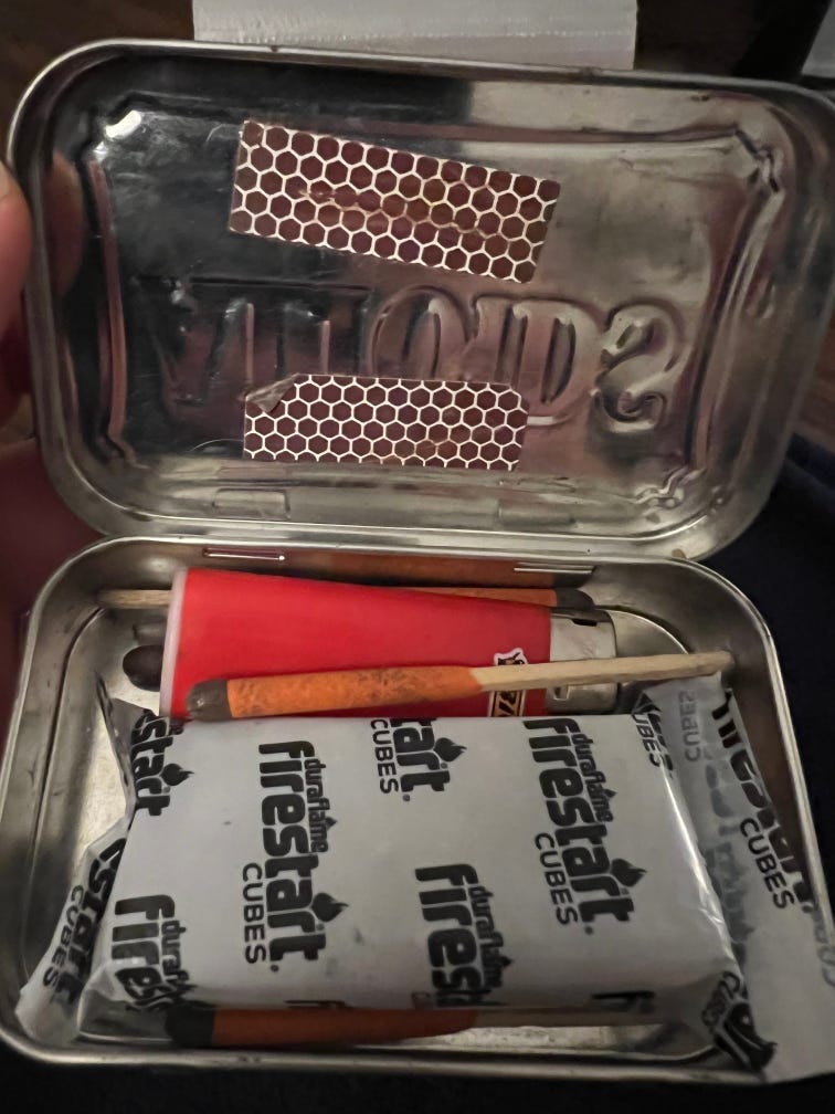 Contents of Altoids fire making kit including Bic lighter, matches and Duraflame cube