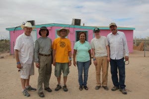 Volunteers pose with one of the teachers from the piñata factory after a day of hard work.