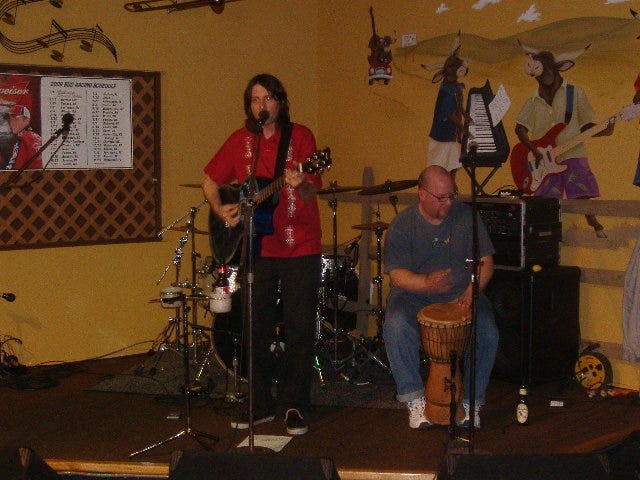 Johnny Suit plays the guitar but I think one of his Nice Ties was at the cleaners. Otherwise wouldn't it be just Johnny Suit and the Nice Tie? They were the last of the four initial acoustic acts.