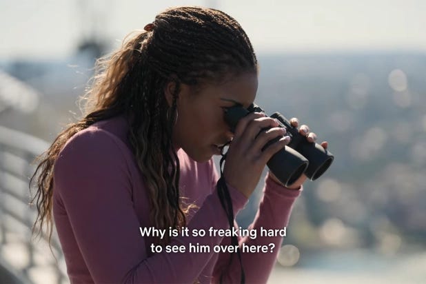 Contestant Kesi from The Mole is holding binoculars and the photo reads "Why is it so freaking hard to see him over here?"