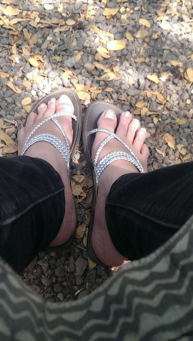 A close up of feet on gravel