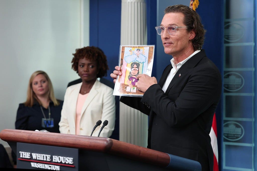 Matthew McConaughey holds up artwork by one of the victims of the school shooting in Uvalde.