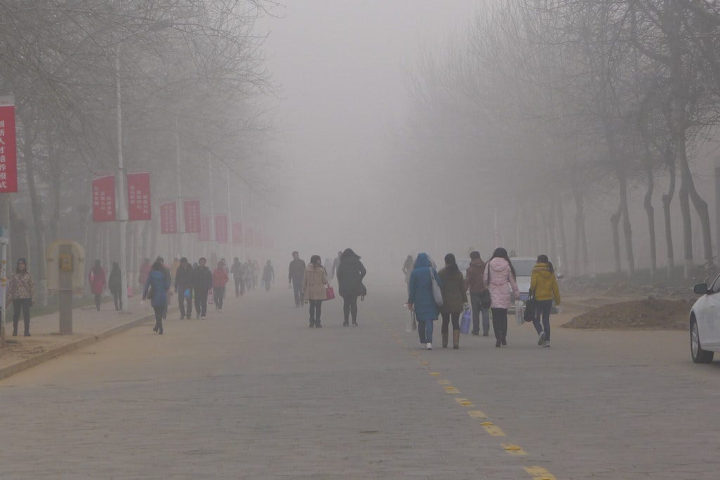 University students come and go in the dense air pollution