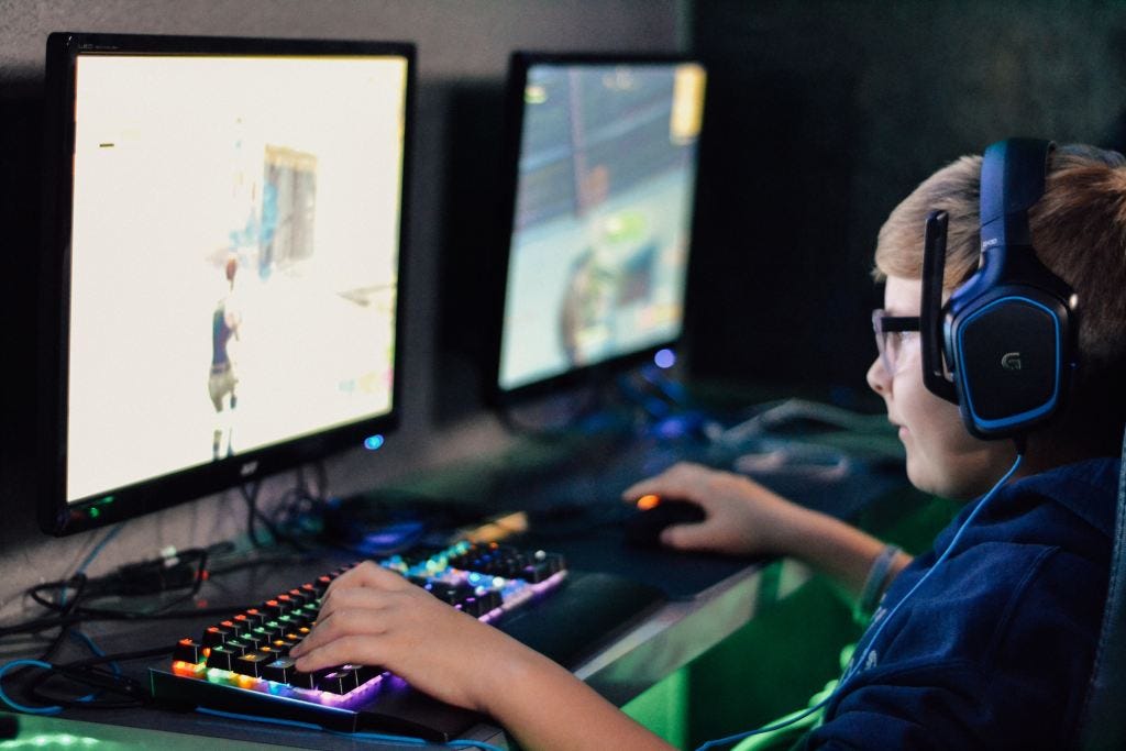 Boy playing video game on computer