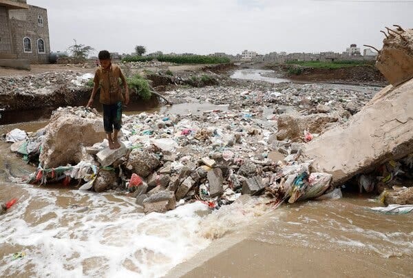 A boy stands at a flooded stream following torrential rains in Sana’a, Yemen, in July 2022, that created a high-risk environment for cholera.