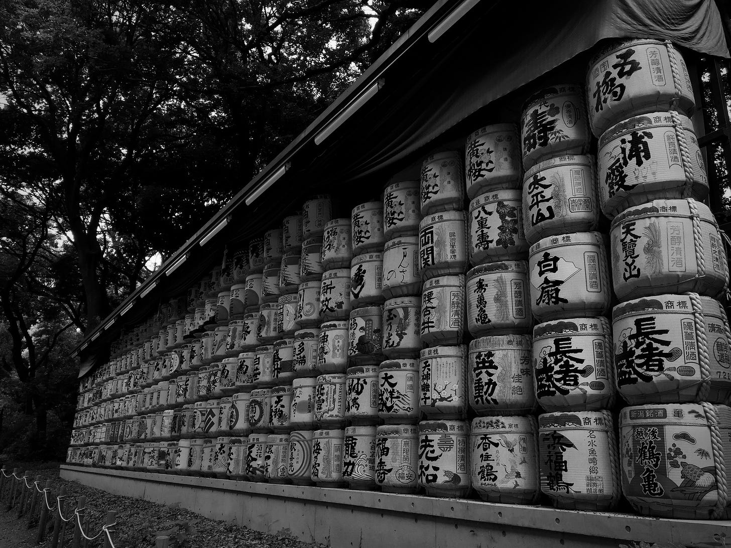 black and white photo of the rice barrels at the Meiji garden and shrine, Tokyo Japan)