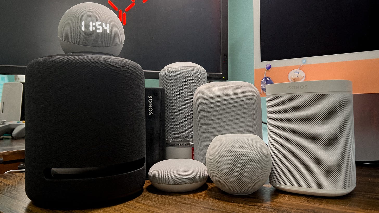 A group of smart speakers on a desk