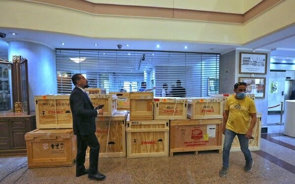 Employees at the Iraqi Ministry of Foreign Affairs in Baghdad on Tuesday working around crates of looted antiquities returned from the United States.