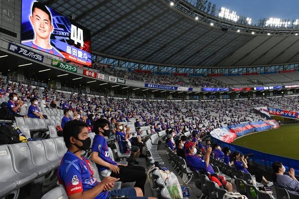 Fans of FC Tokyo showing their support while keeping a social distance during an August match at Ajinomoto Stadium in Tokyo.
