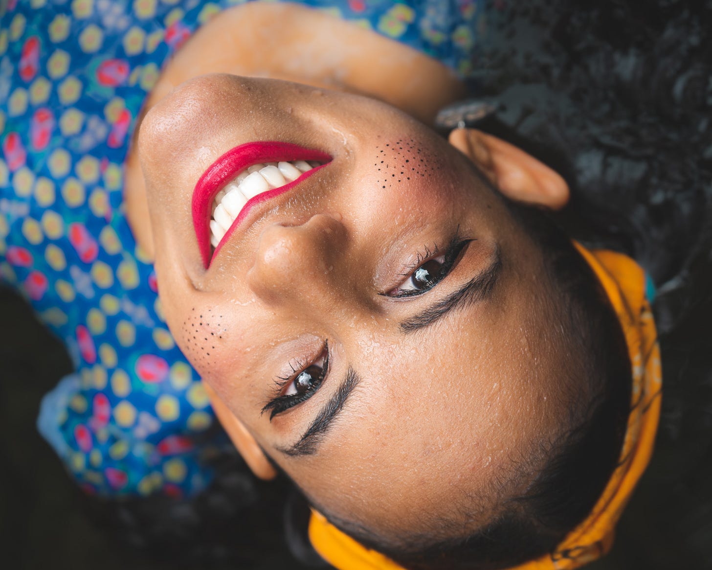 Smiling woman with an orange bandana 