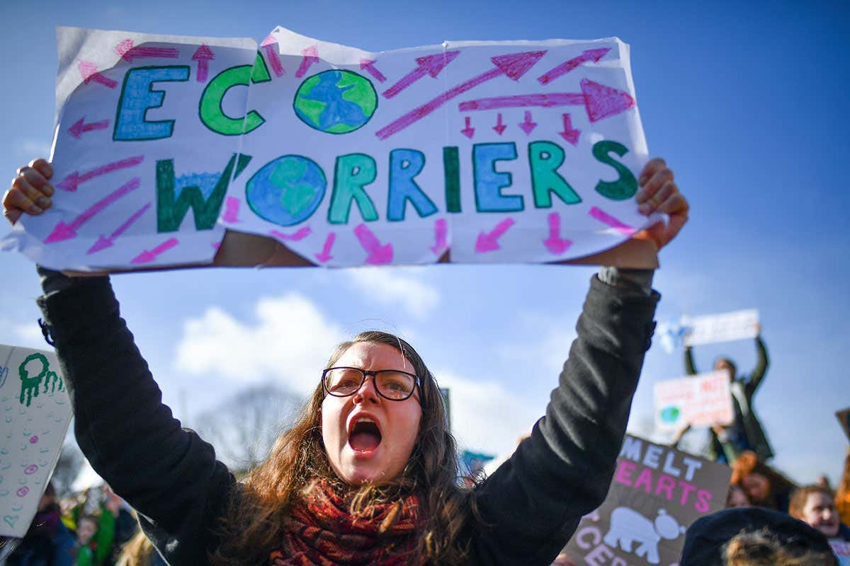 Youth protester holds sign that says 'Eco worrier'