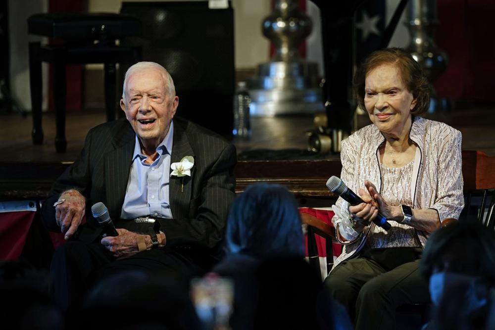 Former President Jimmy Carter and his wife former first lady Rosalynn Carter sit together during a reception to celebrate their 75th wedding anniversary Saturday, July 10, 2021, in Plains, Ga.. (AP Photo/John Bazemore, Pool)
