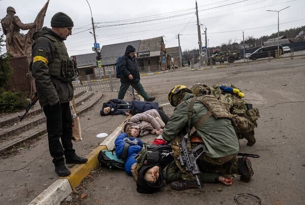 Ukrainian soldiers trying to save the father of a family of four — the only one at that moment who still had a pulse — moments after a mortar hit civilians trying to flee Irpin, near Kyiv, on Sunday.