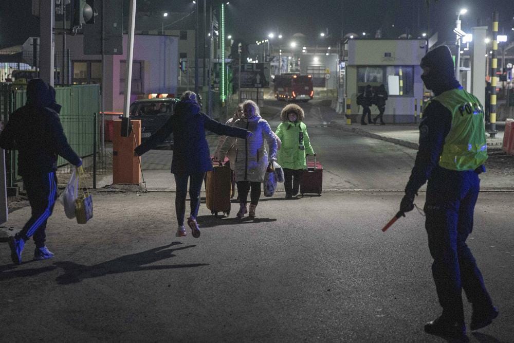 Ukrainian family reunites at the Medyka border crossing in Poland on Sunday, Feb. 27, 2022. The U.N. has estimated the conflict could produce as many as 4 million refugees, depending how long the invasion continues. (AP Photo/Visar Kryeziu)