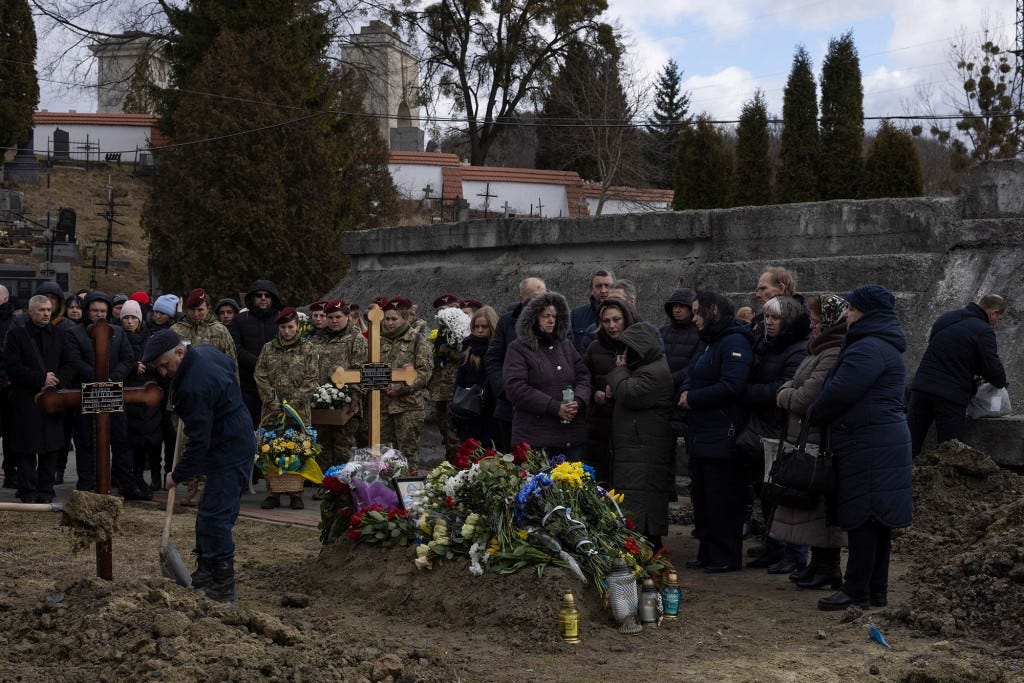 A joint funeral takes place at 'Saint's Peter and Paul Garrison Church', for two soldiers who died in the east of the country during recent fighting.