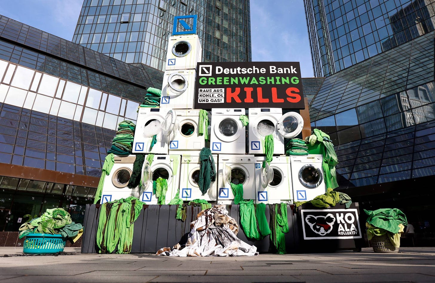 Activists place washing machines in front of the Deutsche Bank headquarters to protest against greenwashing during the banks annual shareholders meeting in Frankfurt, Germany, on May 19. | REUTERS