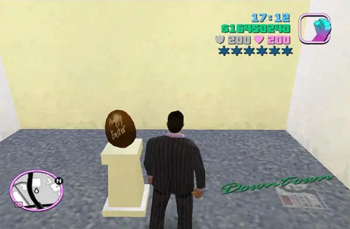 Screenshot of Grand Theft Auto: Vice City. Your character stands in front of a pedestal with an egg on top of it. The egg reads "Happy Easter"