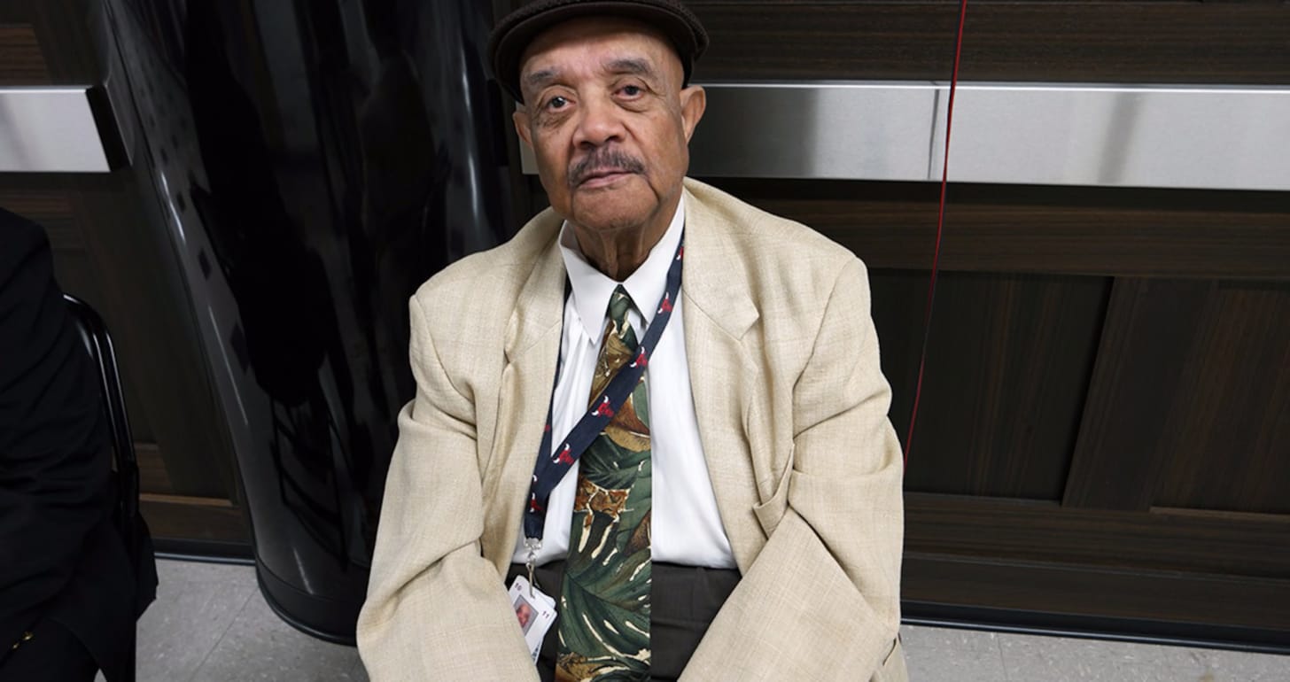 John Capps in his signature Kangol hat, sits outside the Locker Room as security for the team