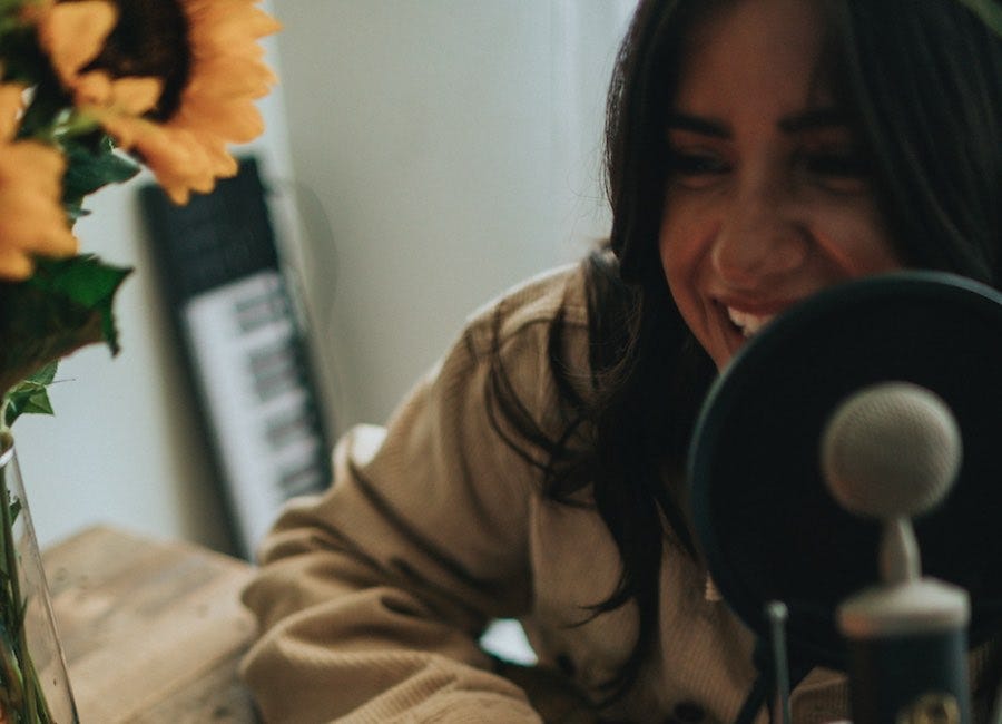 Woman speaking into podcast microphone