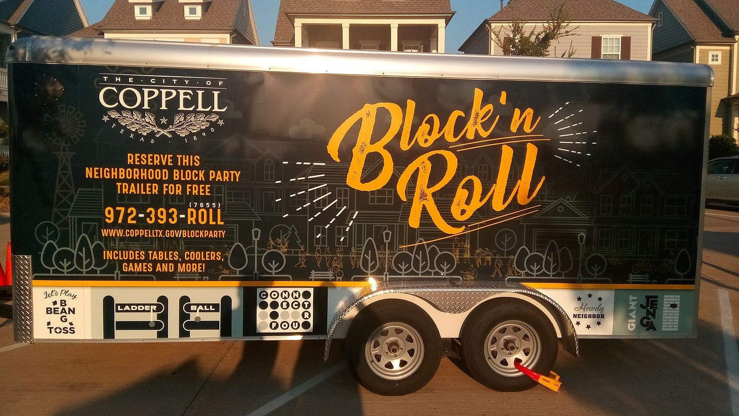 A 16-foot trailer bearing the City of Coppell logo and the phrase "Block'n Roll"