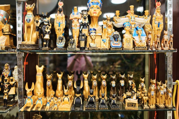 Shelves with souvenirs in the oriental shop. Shelves with souvenirs in the oriental shop. Many different authentic figurines on Egyptian themes Buying Souvenirs stock pictures, royalty-free photos & images