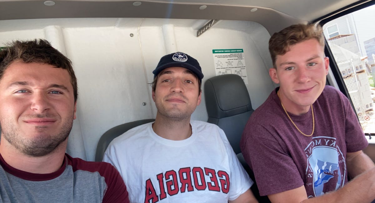 A group of men sitting in a bus

Description automatically generated with low confidence
