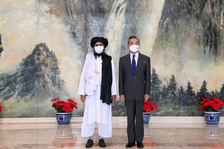 Chinese State Councilor and Foreign Minister Wang Yi (R) meeting with Mullah Abdul Ghani Baradar, political chief of Afghanistan's Taliban, in Tianjin [Li Ran / Xinhua/AFP]