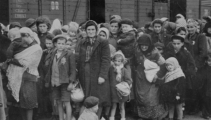 Jewish women and children from Subcarpathian Rus, then a part of Hungary, await selection on the ramp at Auschwitz-Birkenau. 1944.
