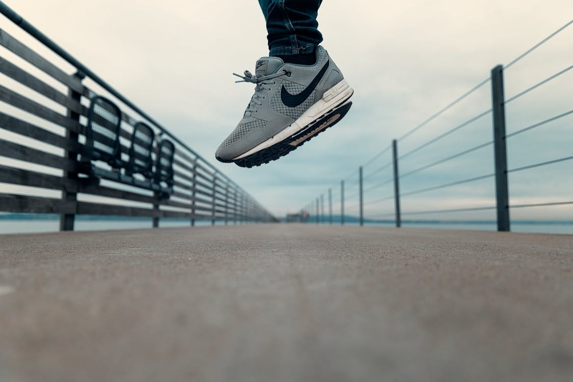 Free Person Wearing Gray Nike Shoes Stock Photo