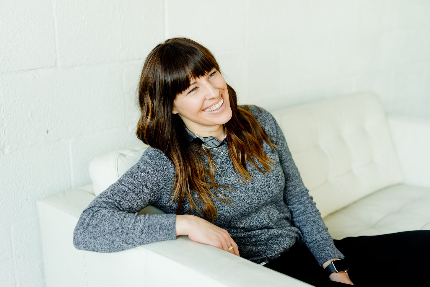 Woman on a sofa smiling